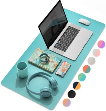 The turquoise pad with a laptop and accessories on top of it 