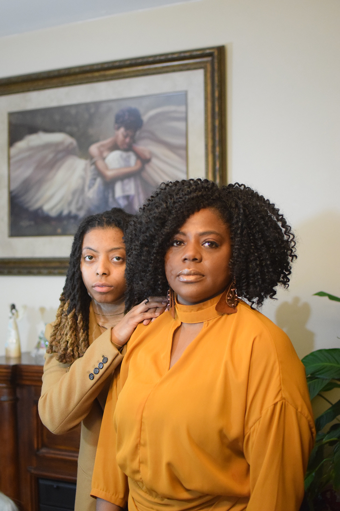 An older woman and her daughter look in a mirror