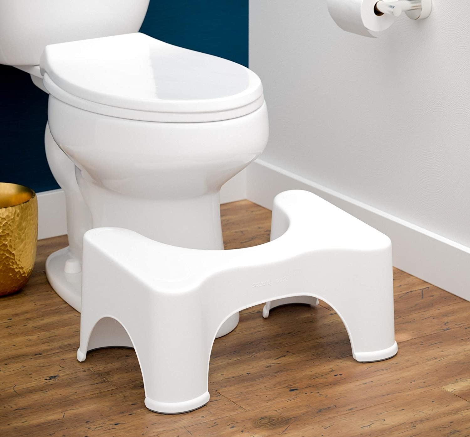 the squatty potty at the foot of a toilet