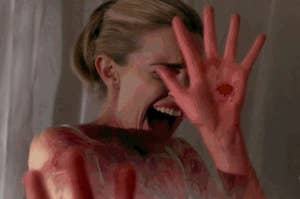 A girl with bloody hands shielding her face and screaming