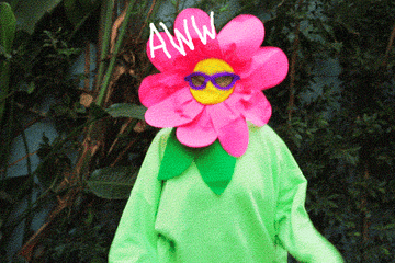 Someone dressed in a flower costume, pumping up their hands and saying &quot;Aww yeah!&quot;