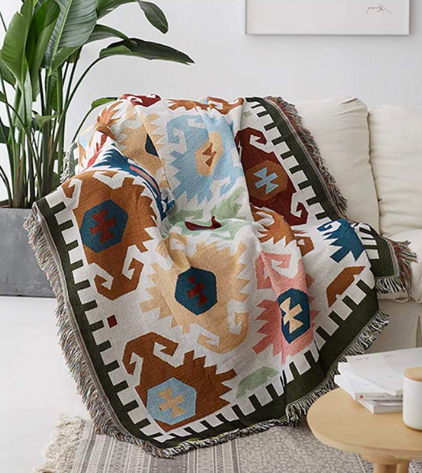 Fringe-covered throw blanket with colorful pattern 