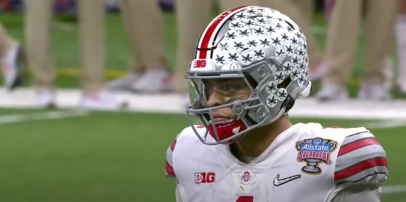 Silver helmet with buckeye stickers all over it