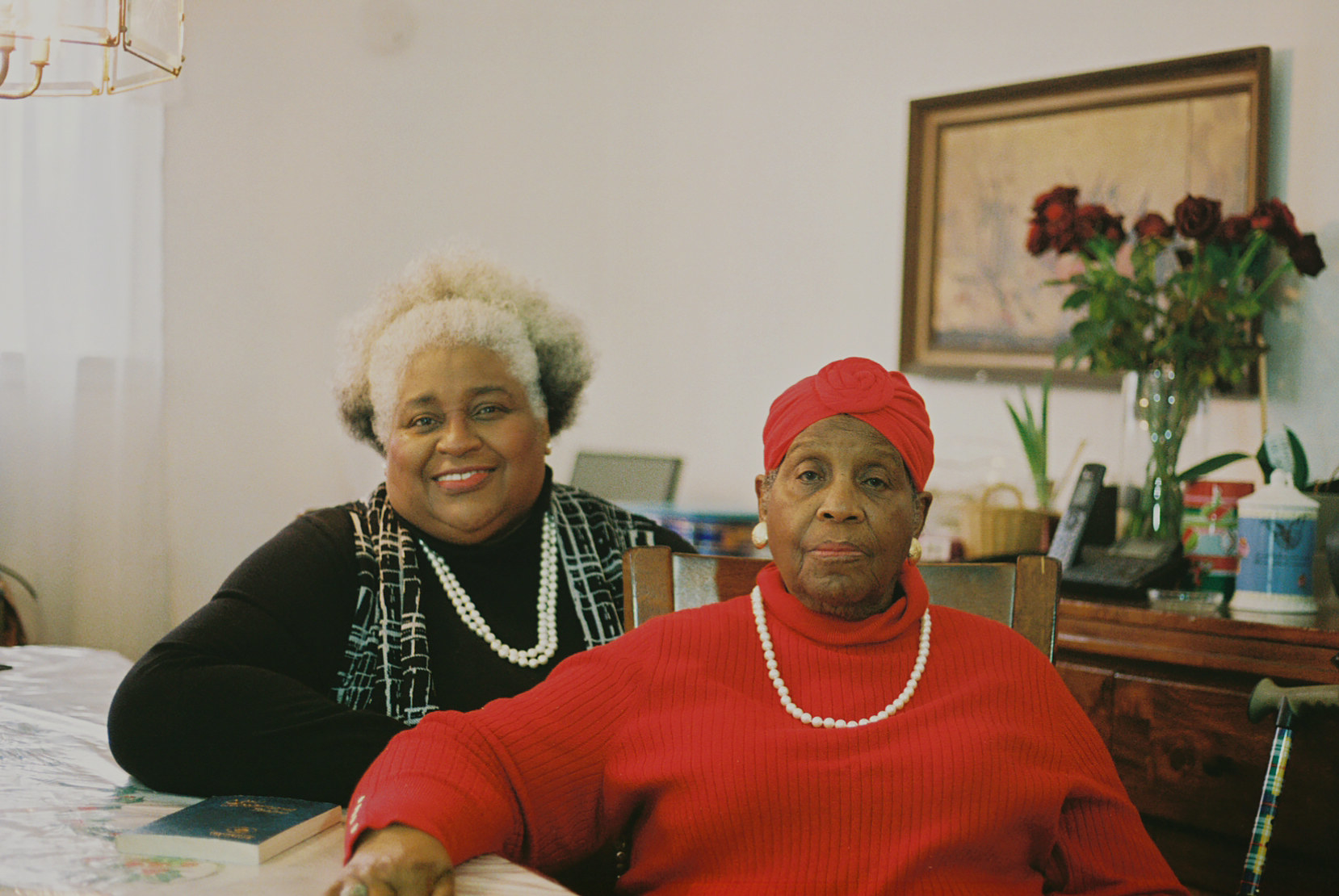 Two older women at a dining room table 