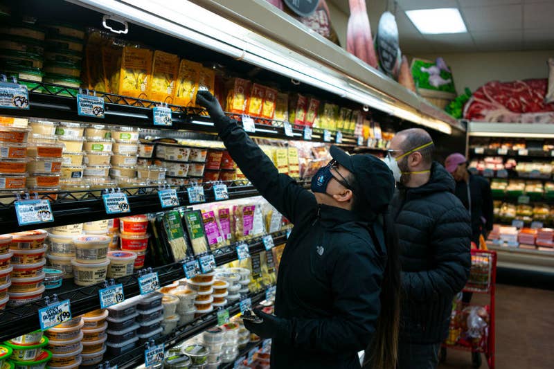 Masked customers shopping in a grocery store