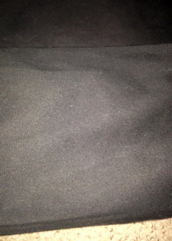 A dog bed without any dog hair on it, after being vacuumed 