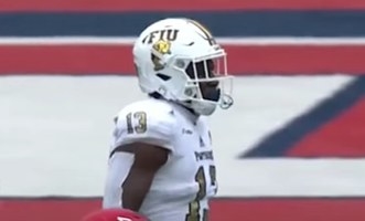 White helmet with purple letters spelling &quot;FIU&quot; and below is a gold panther