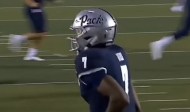 Silver helmet with blue letters spelling &quot;Pack&quot; in cursive