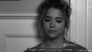 A woman with her eyes closed with the caption &quot;I might seem strong, but I break&quot;