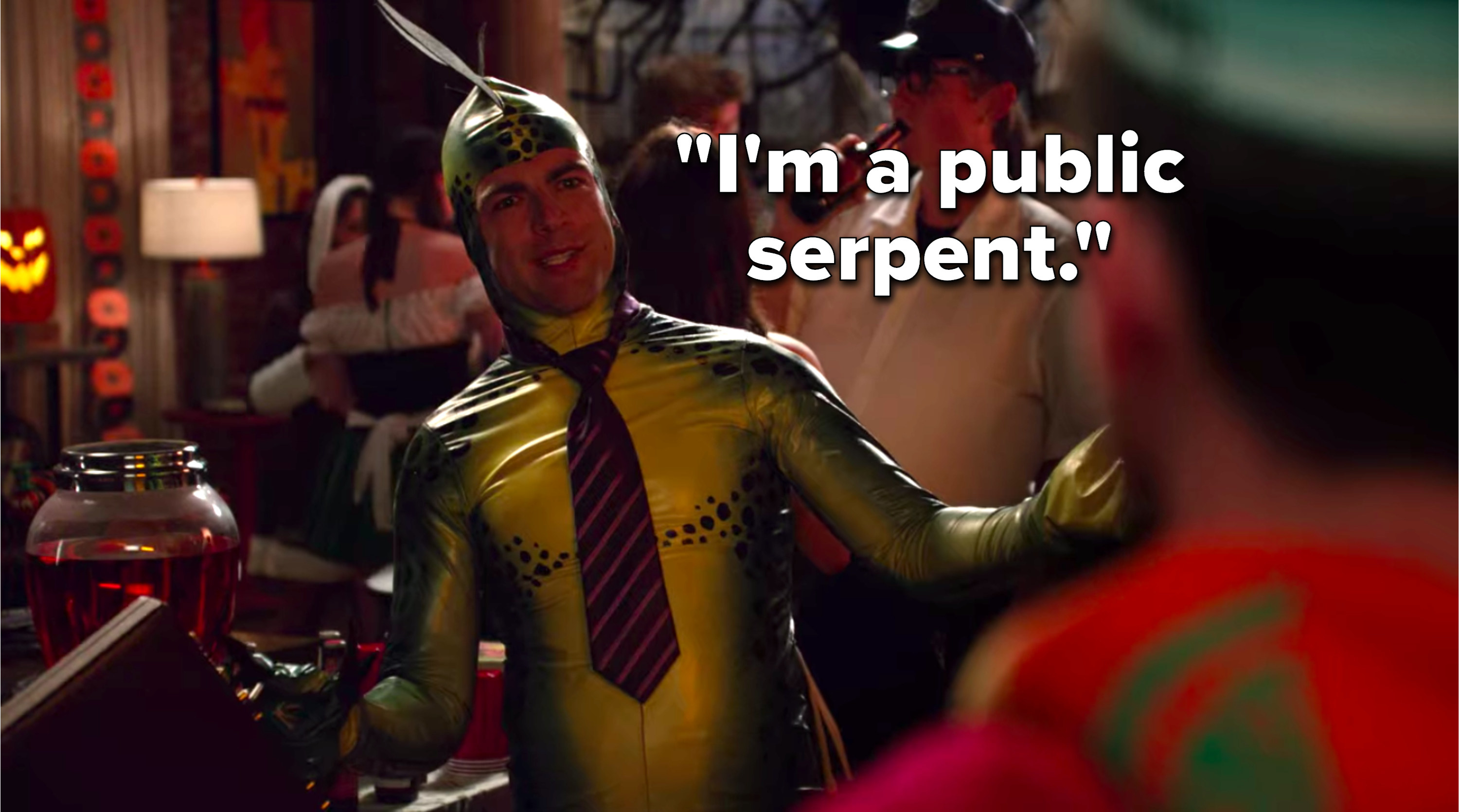 Schmidt is dressed up in a snake costume with a tie and a briefcase and he says, I&#x27;m a public serpent