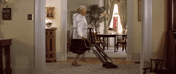 Mrs. Doubtfire spinning around with a vacuum