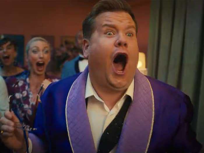 James Corden in a robe with his mouth open wide as if in shock