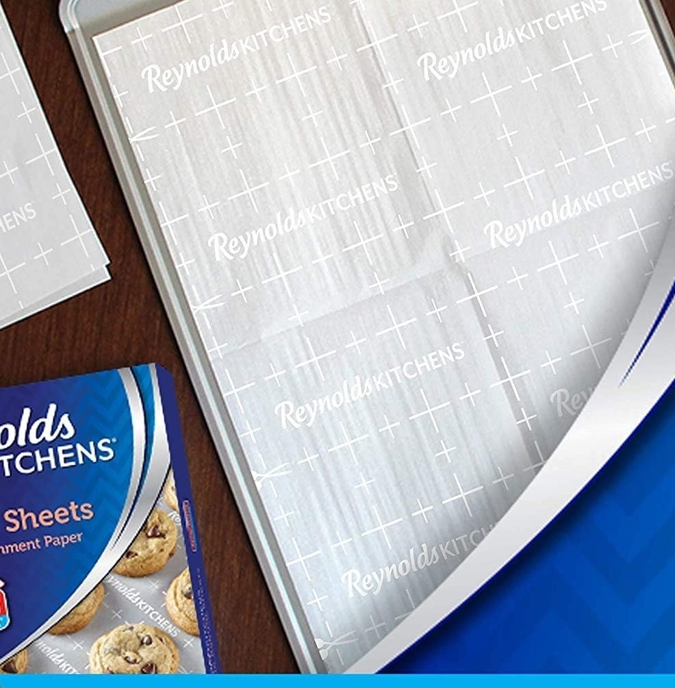 One sheet on a baking tray next to several folded sheets