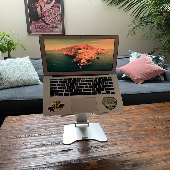 The laptop stand positioning the computer at a comfortable angle