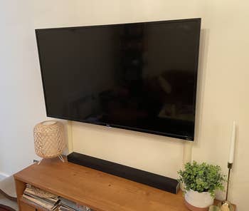 A BuzzFeeder's TV with the beige cord cover