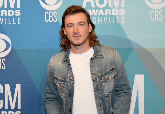Morgan, who has a mullet, wears a plain T-shirt and a denim jacket on the American Country Music Awards red carpet