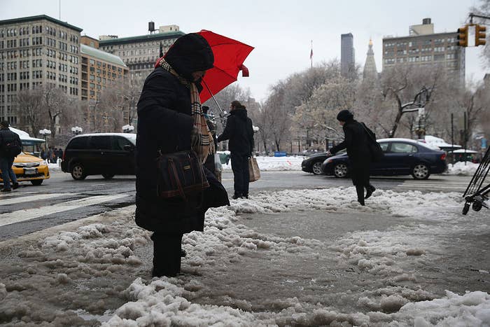 A person who has sunk in some snow on a sidewalk