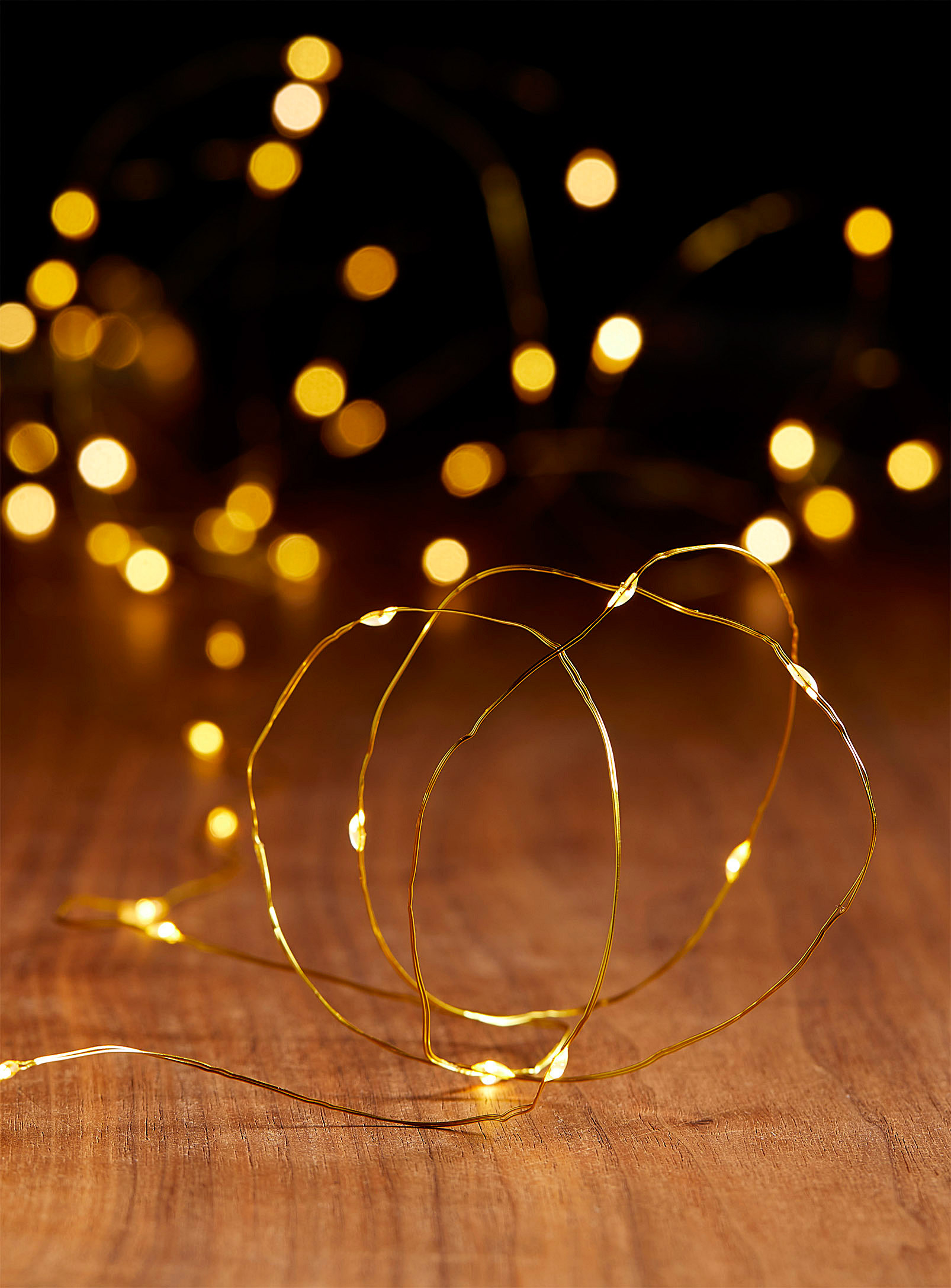 A string of fairy lights on a wooden floor