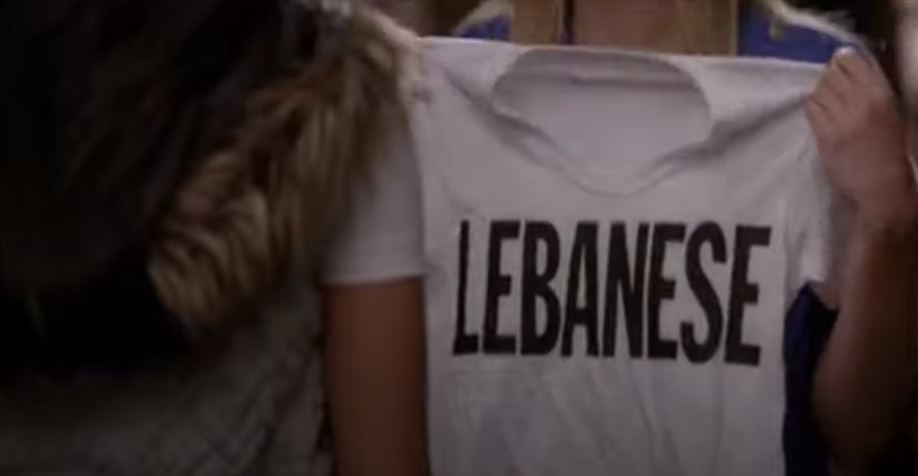 A person holding up a T-shirt that says Lebanese