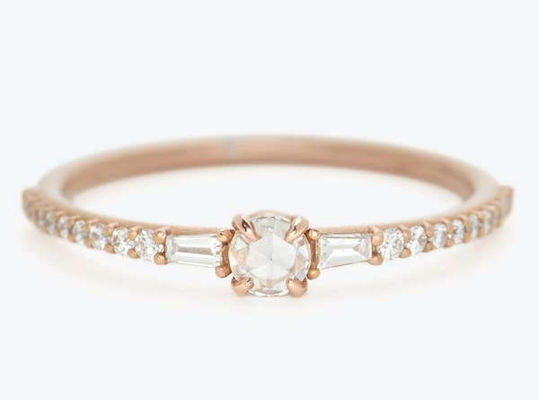 the gold band with a larger diamond center and smaller diamonds throughout