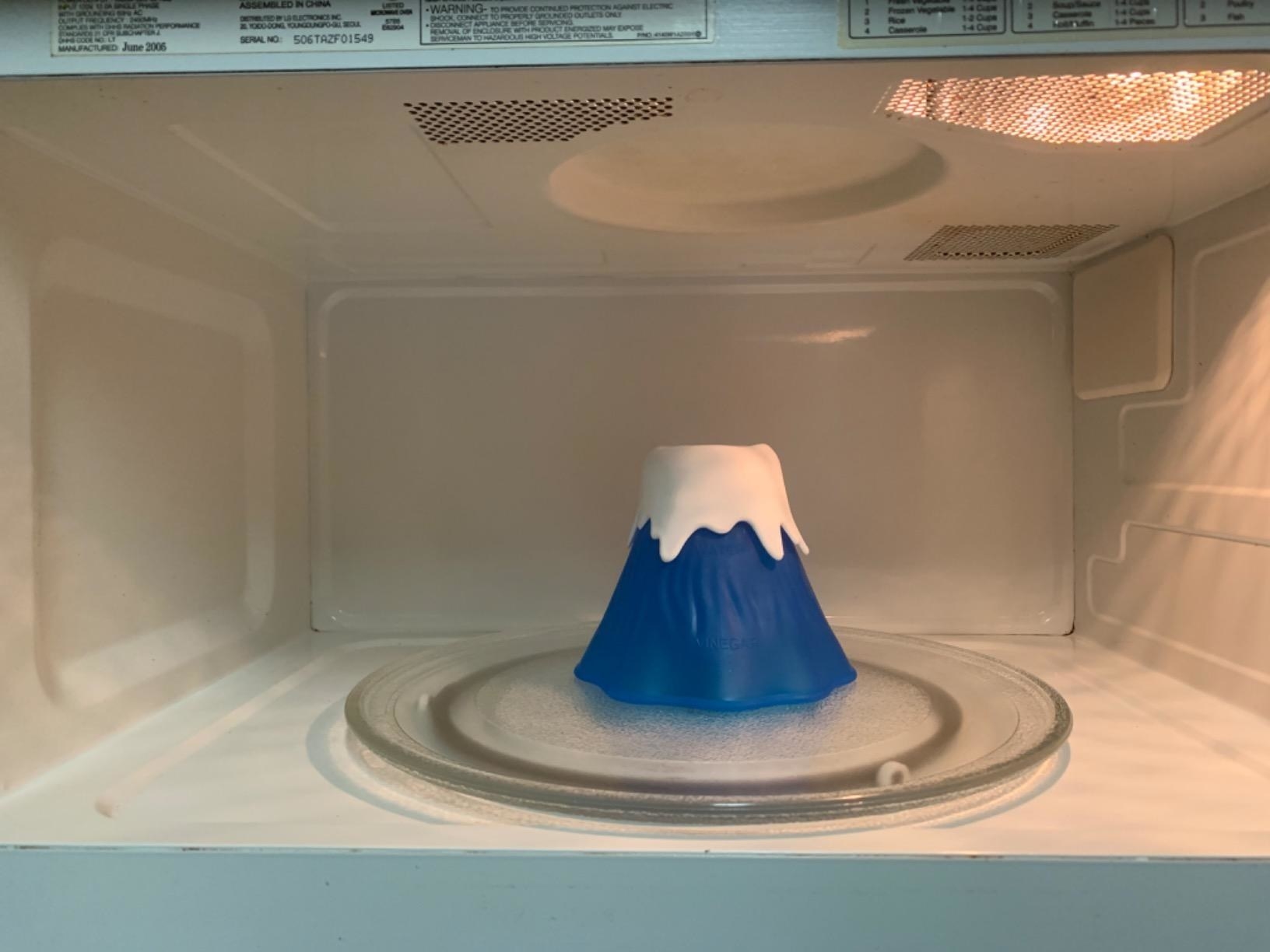 blue plastic volcano in a microwave