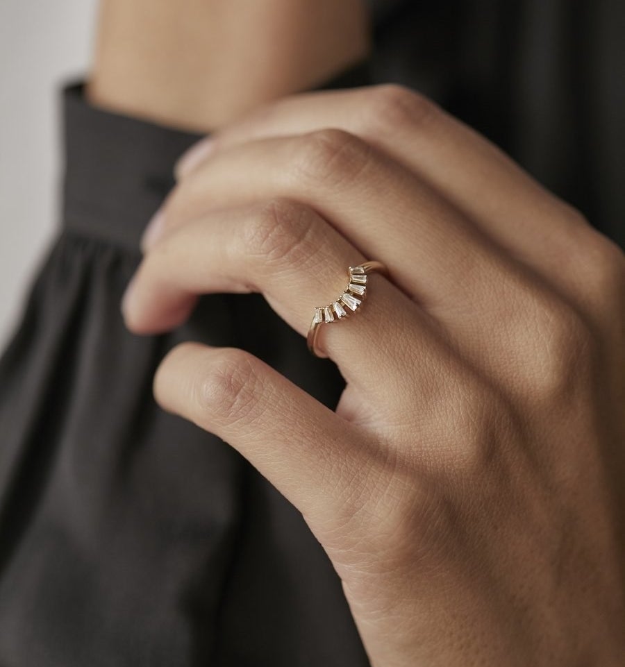 the model wearing the curved baguette ring