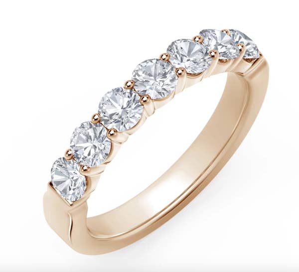 the gold band with seven circular diamonds