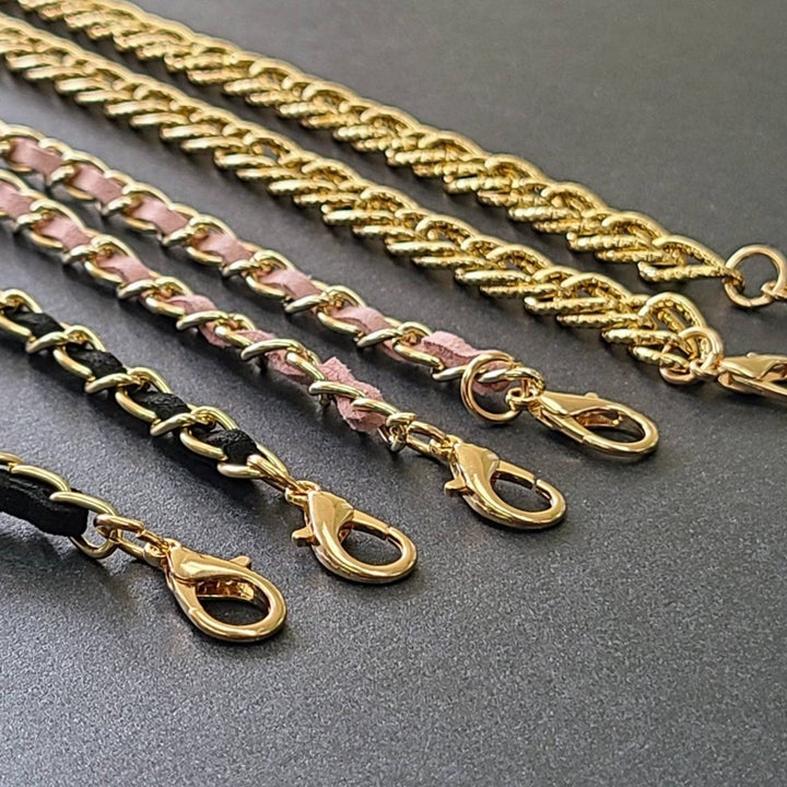 The lanyards in black, pink, and gold with small hooks at the end of them 