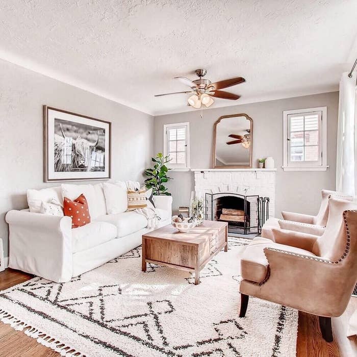 The tasseled beige area rug in a living room
