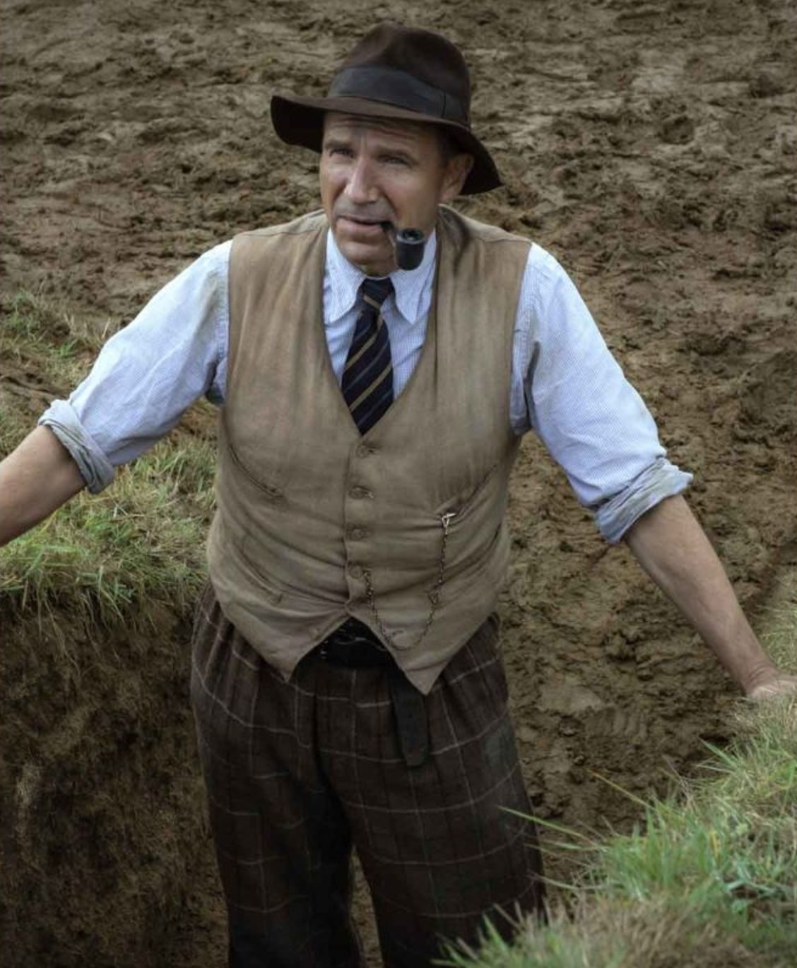 Still from The Dig: Basil Brown in vest, button-down, and trousers at the excavation site