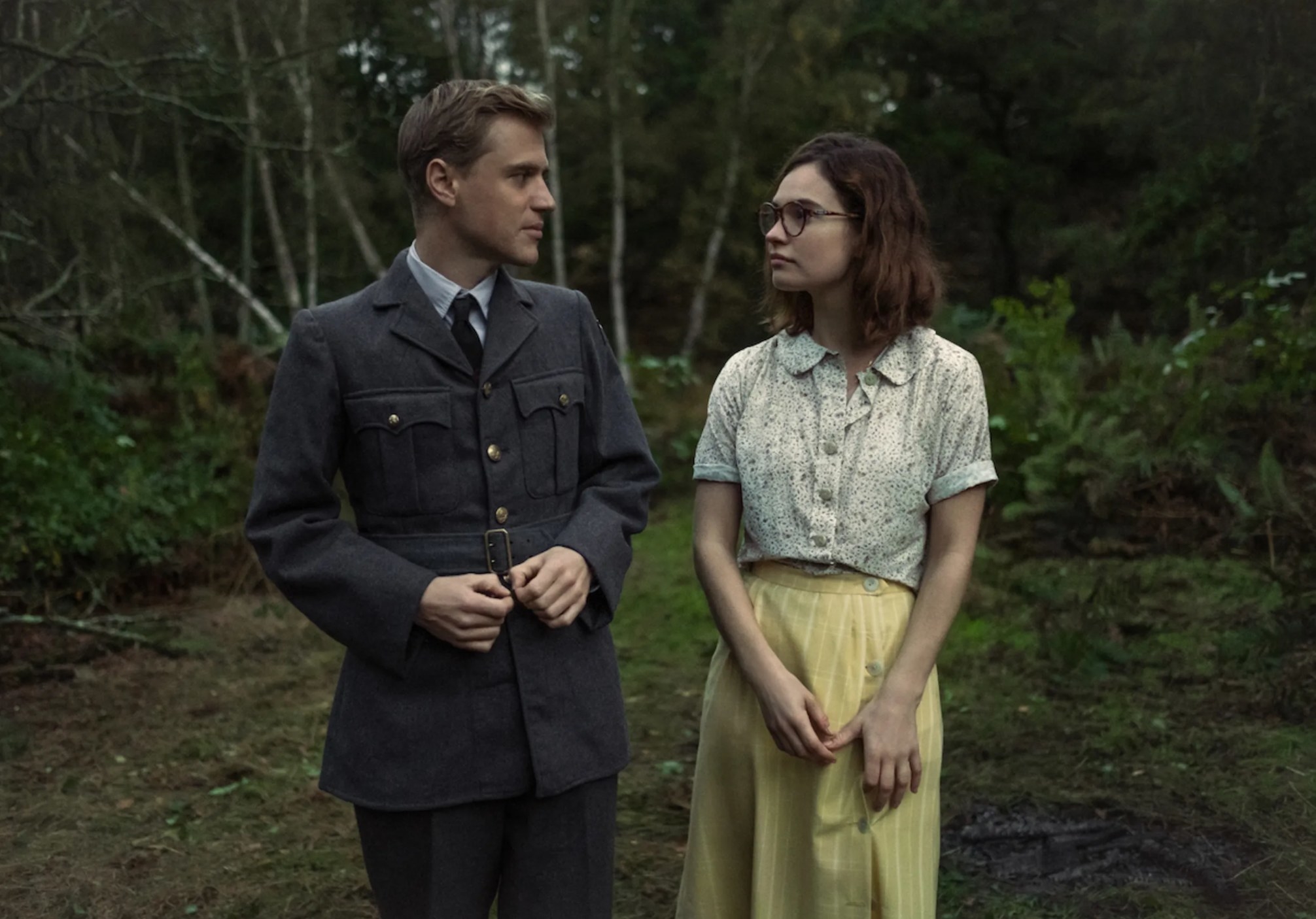 Still from The Dig: Peggy and Rory walking in a forest 