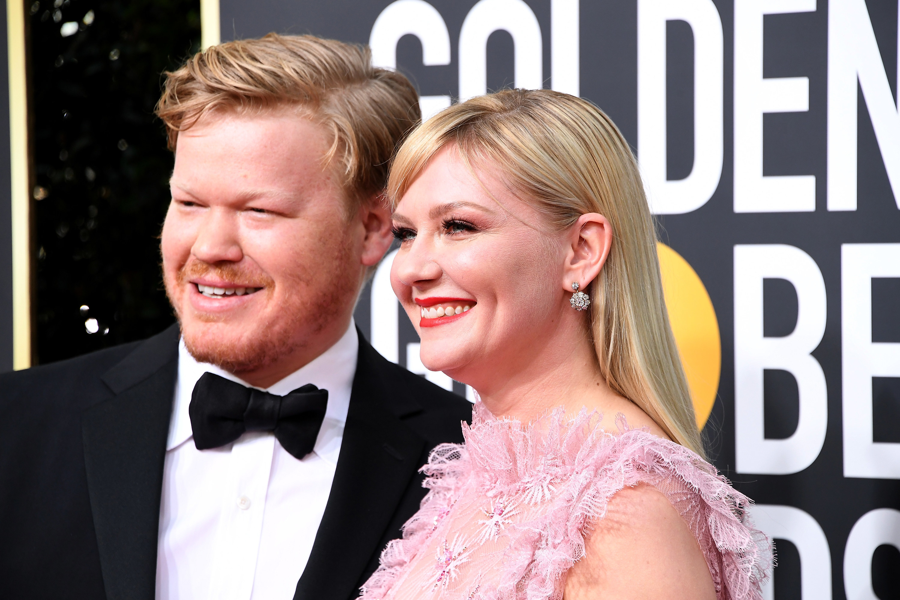 Jesse Plemons and Kirsten Dunst smiling at the Golden Globes