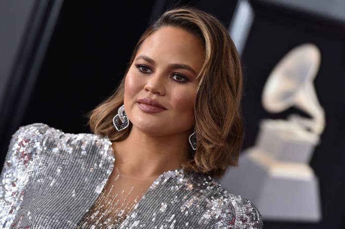 Chrissy on the Grammy&#x27;s red carpet wearing a sequined dress, drop earrings, and her hair down