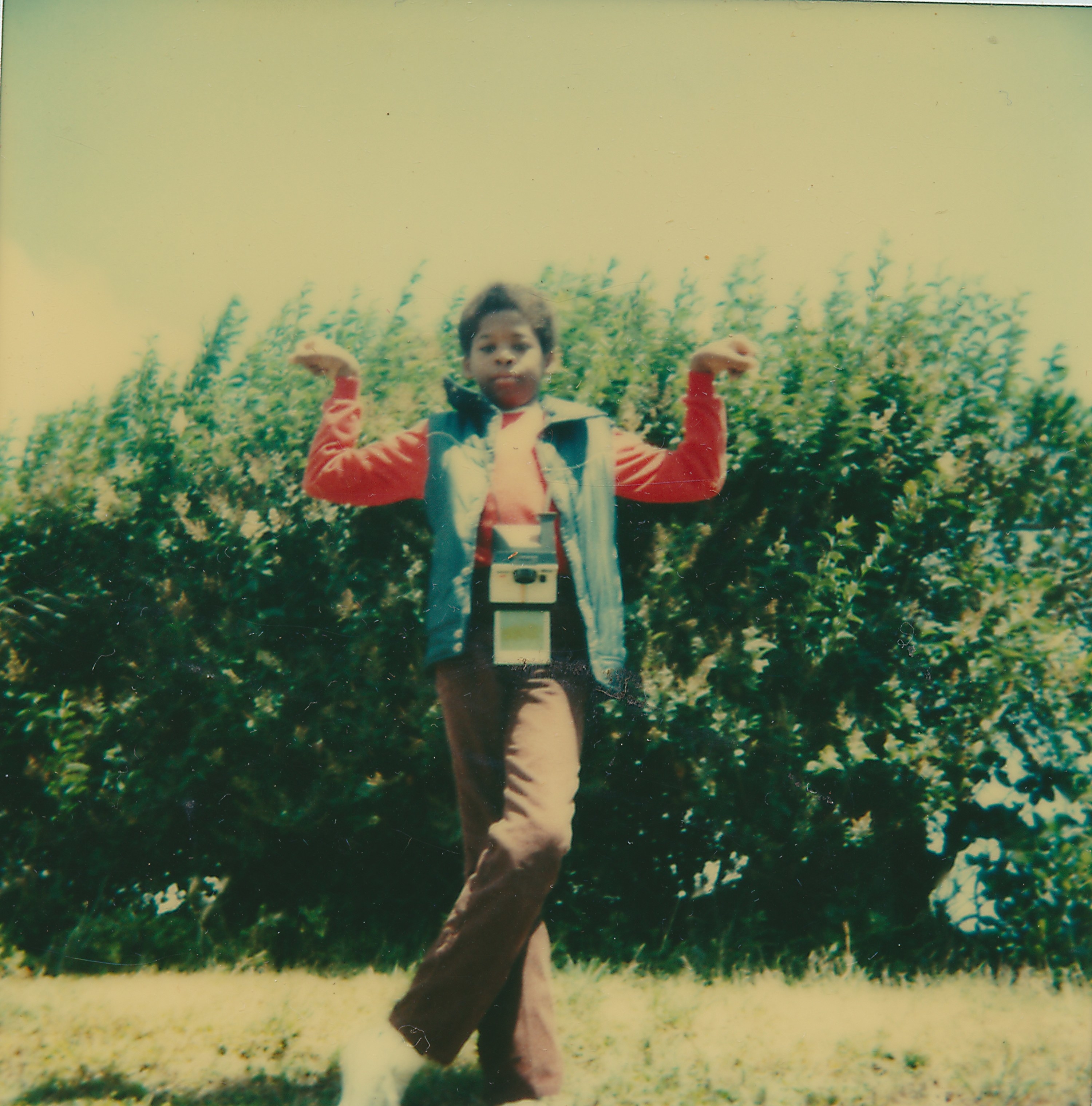 Polaroid photograph of a young Black boy striking an Egyptian style pose