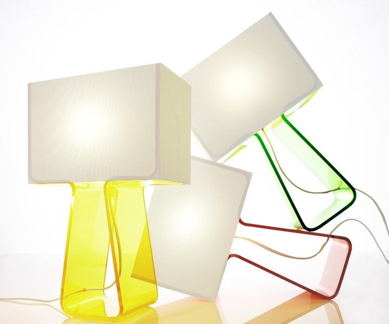 three tube top lamps of different colors displayed toppled on top of each other