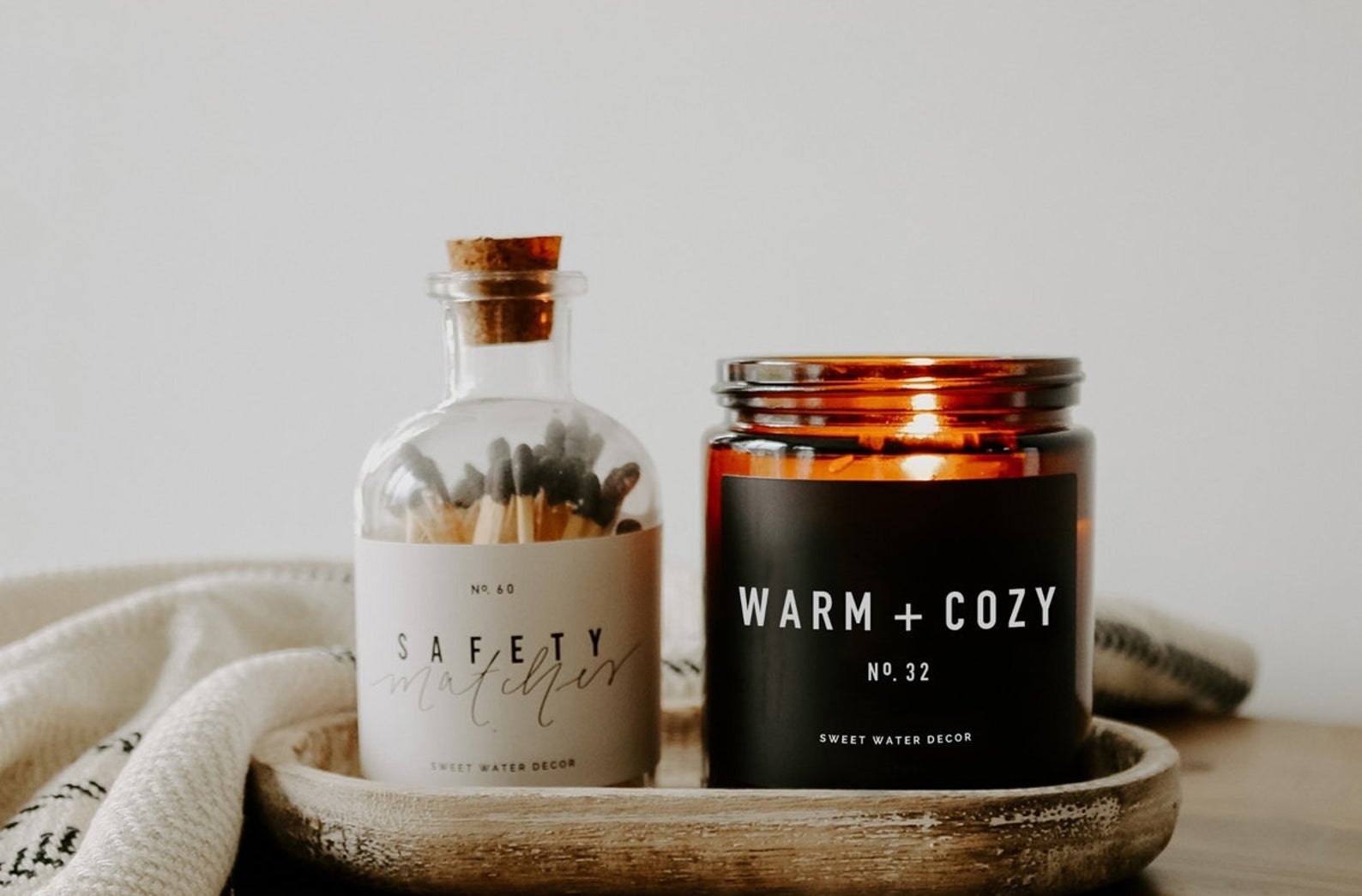 the lit warm and cozy candle