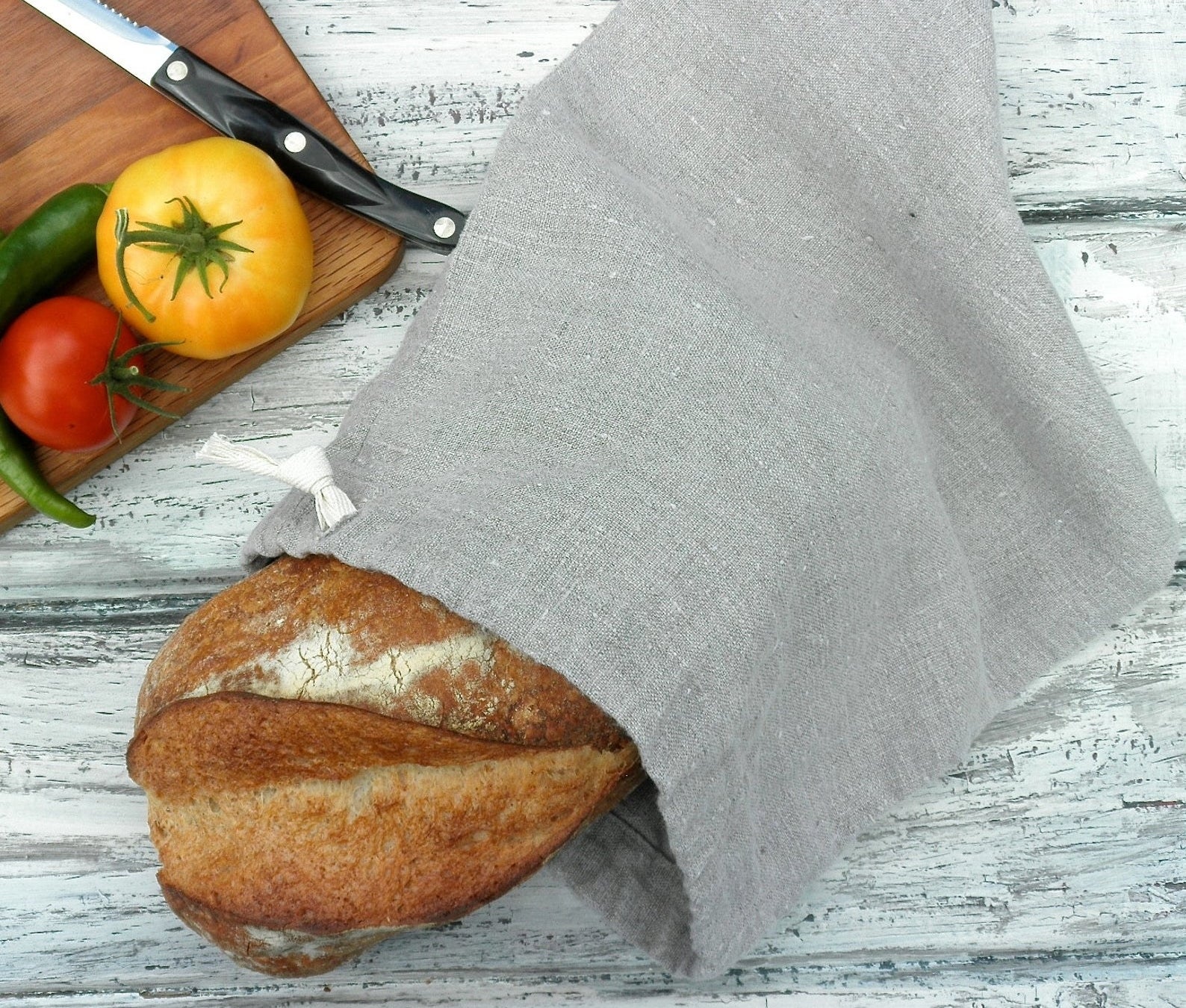 a loaf of bread inside a gray linen bag