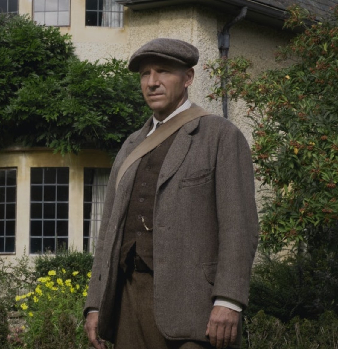 Still from The Dig: Basil Brown in front of a house 