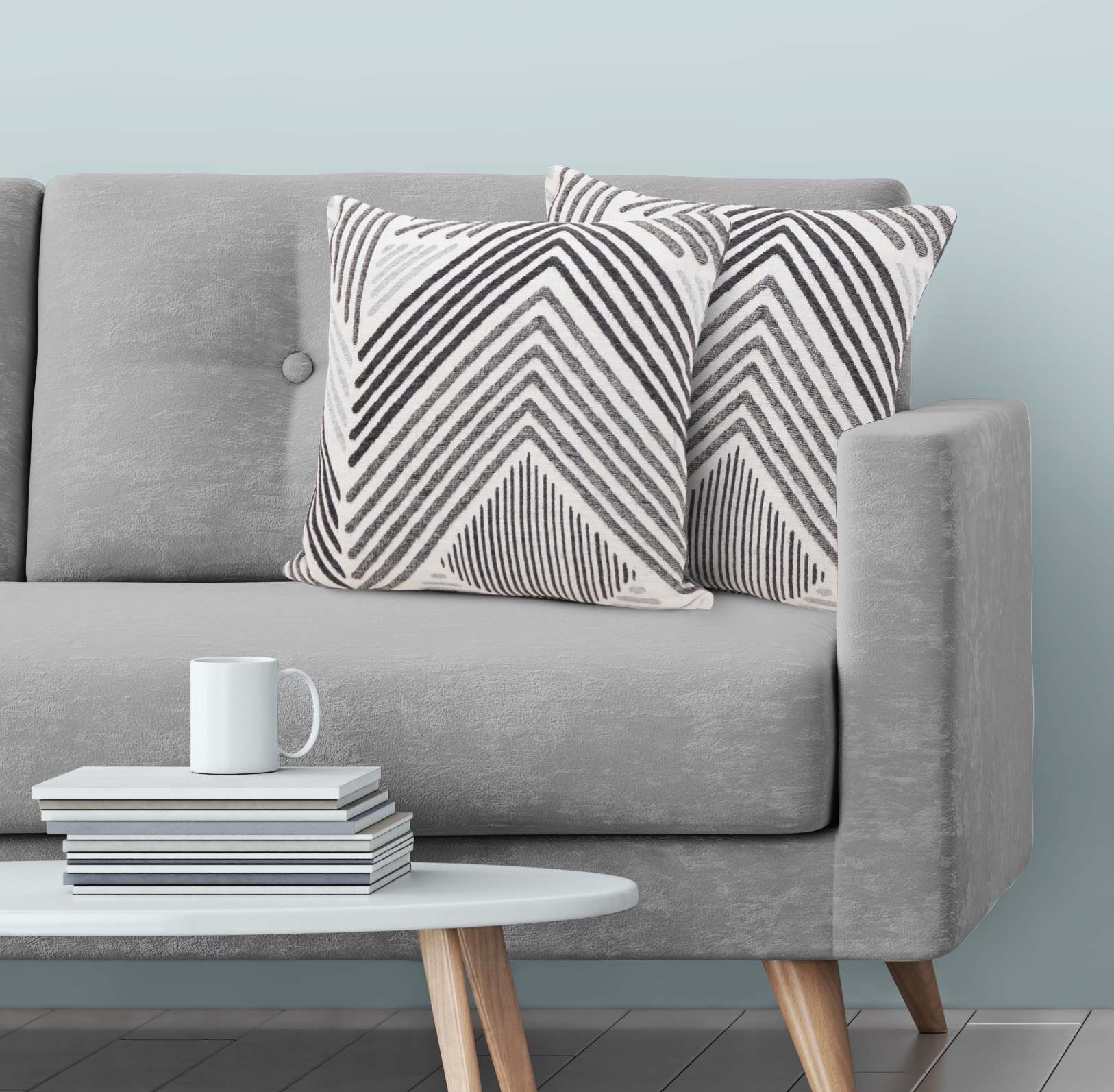 The pillows, which are small and square throw pillows, with a light gray base, and chevron stripe patterns in darker gray