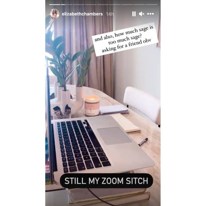 The candle and sage are next to her work-from-home setup which includes a laptop sitting on top of two books and open notepads on the table