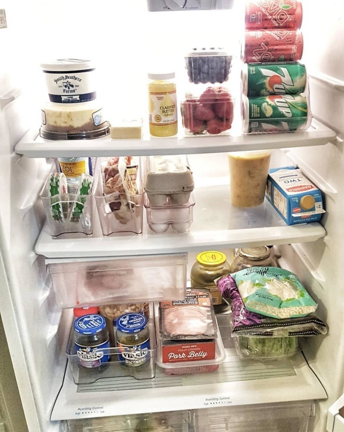 A reviewer photo of an open fridge organized with clear plastic bins 