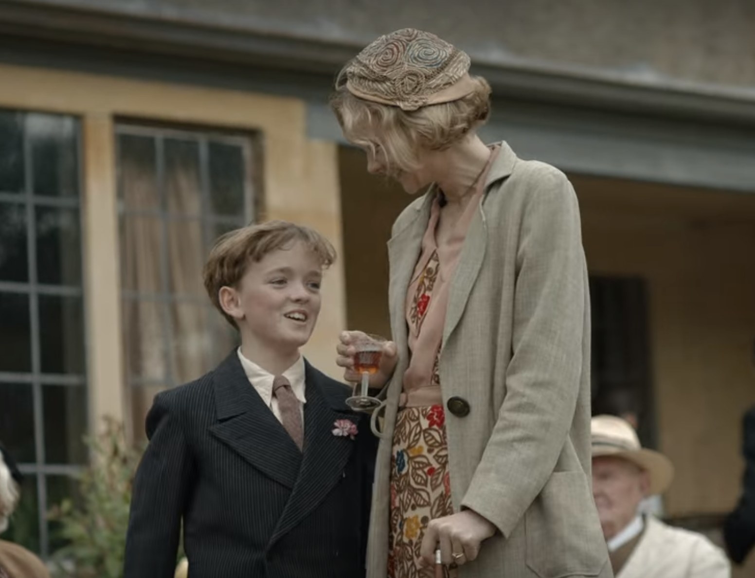 Still from The Dig: Mrs. Pretty and Robert in elegant outfits