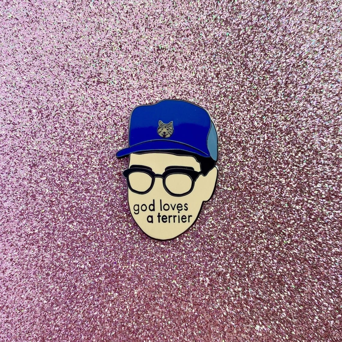 minimalist eugene levy wearinh terrier hat that says god loves a terrier on it