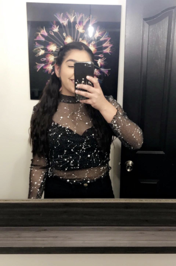 reviewer wearing sheer star top in mirror selfie 