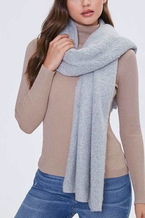 Model wears heather gray scarf with blue jeans and a brown top