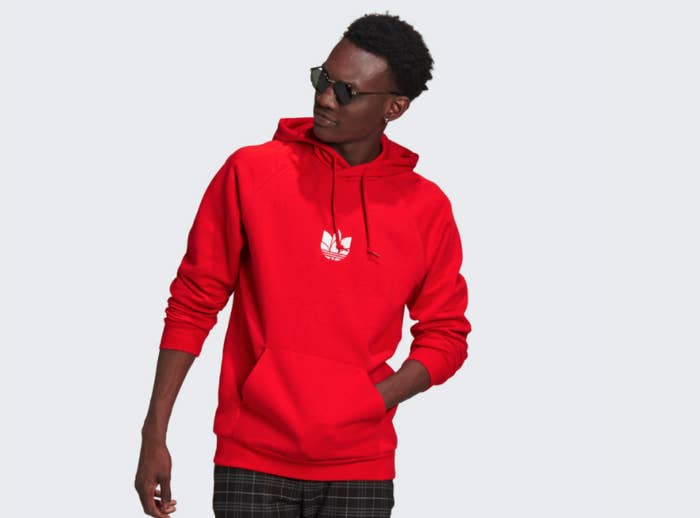 Model wearing a red Adidas hooded sweatshirt 