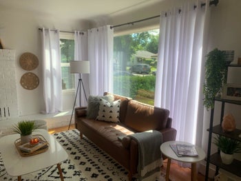 A reviewer's photograph of the white curtains of their front room