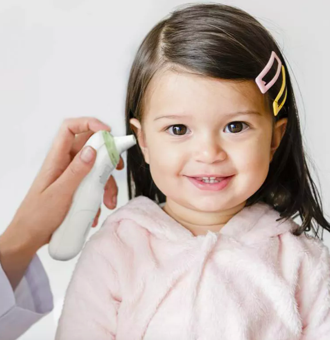 Parent placing thermometer by child&#x27;s ear 