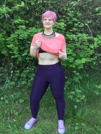 Reviewer wears same style workout leggings in a dark purple color