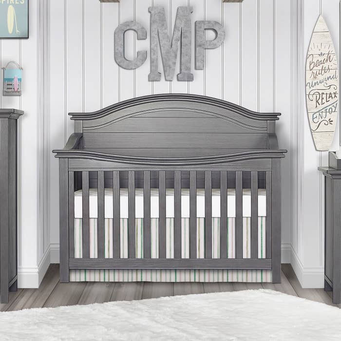 gray convertible crib in a nursery